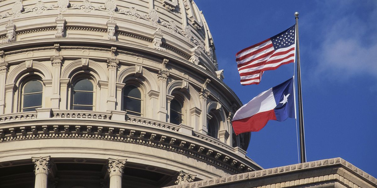 U.S. and Texas flags fly over the Texas Capitol