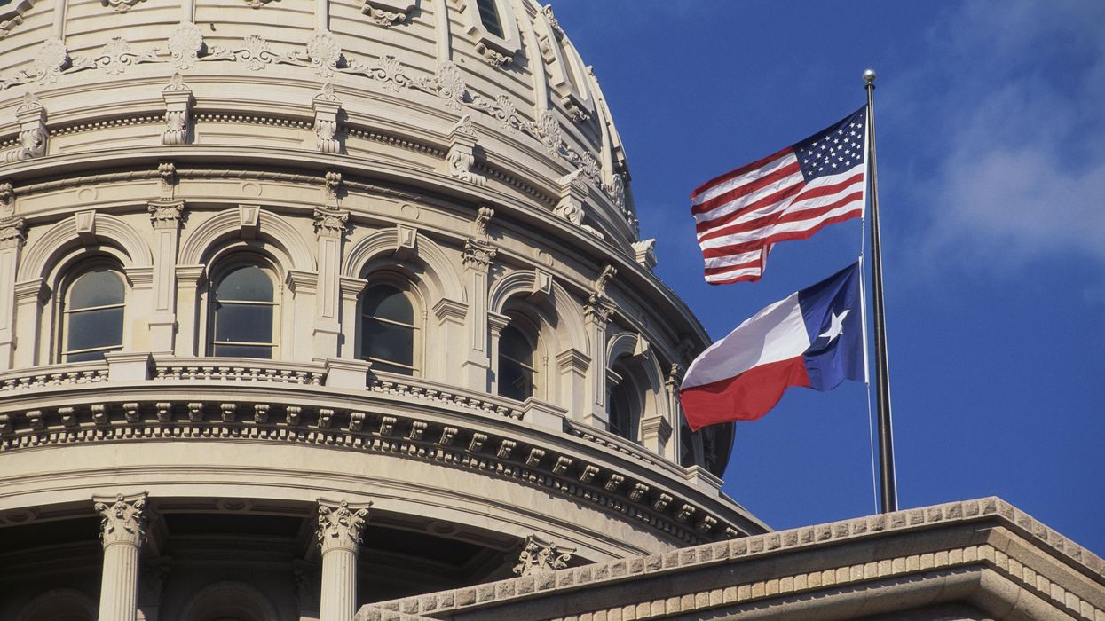 U.S. and Texas flags fly over the Texas Capitol