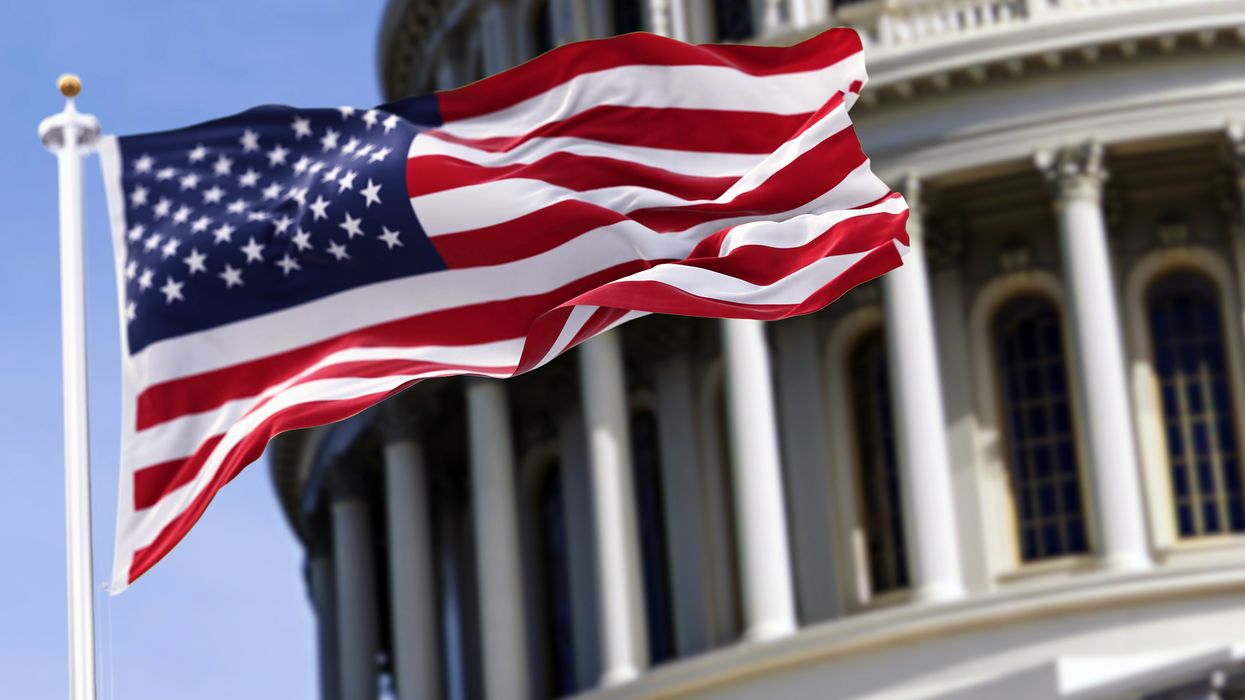 U.S. flag flapping in front of the Capitol Dome