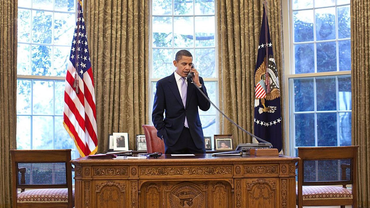 U.S. President Barack Obama speaking on the phone in the Oval Office.