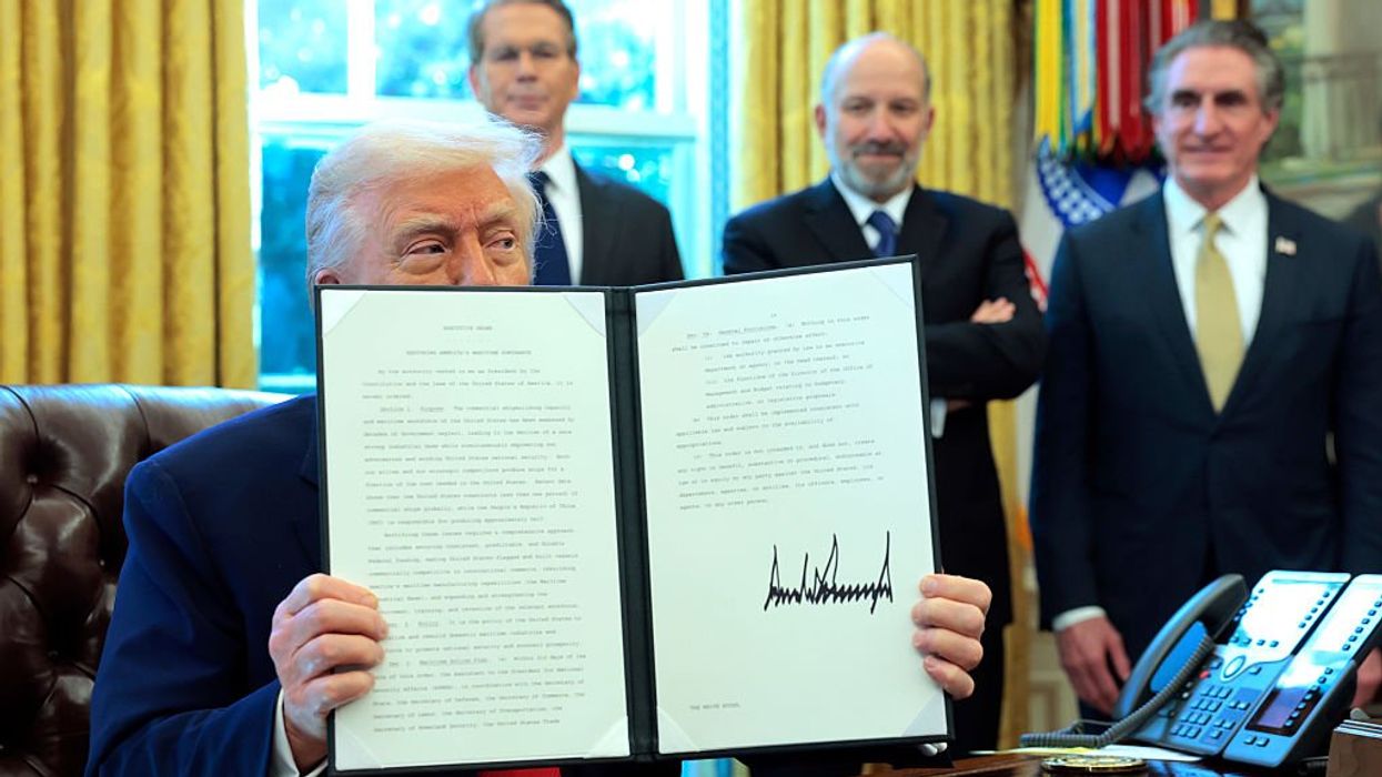 U.S. President Donald Trump holds up a signed executive order as (L-R) U.S. Treasury Secretary Scott Bessent, Secretary of Commerce Howard Lutnick and Interior Secretary Doug Burgum look on in the Oval Office of the White House on April 09, 2025 in Washington, DC.