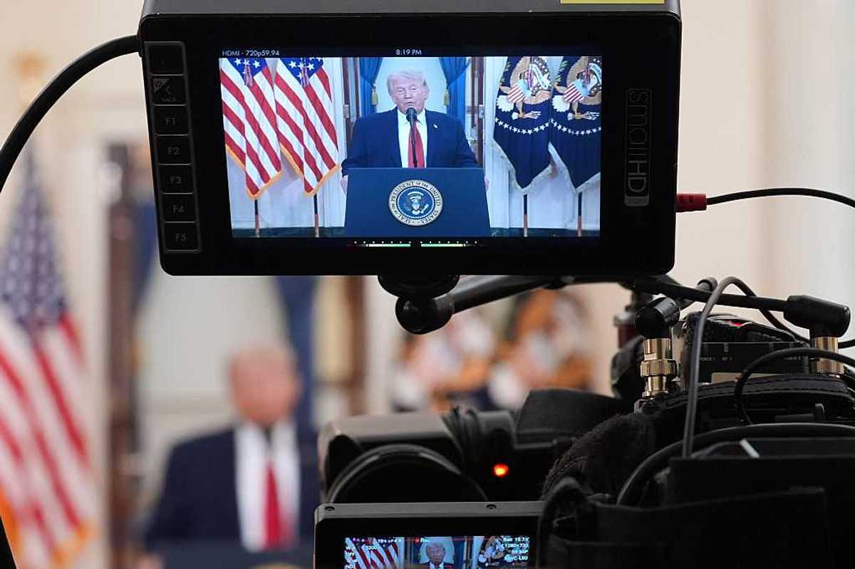 U.S. President Donald Trump is shown on television monitor.