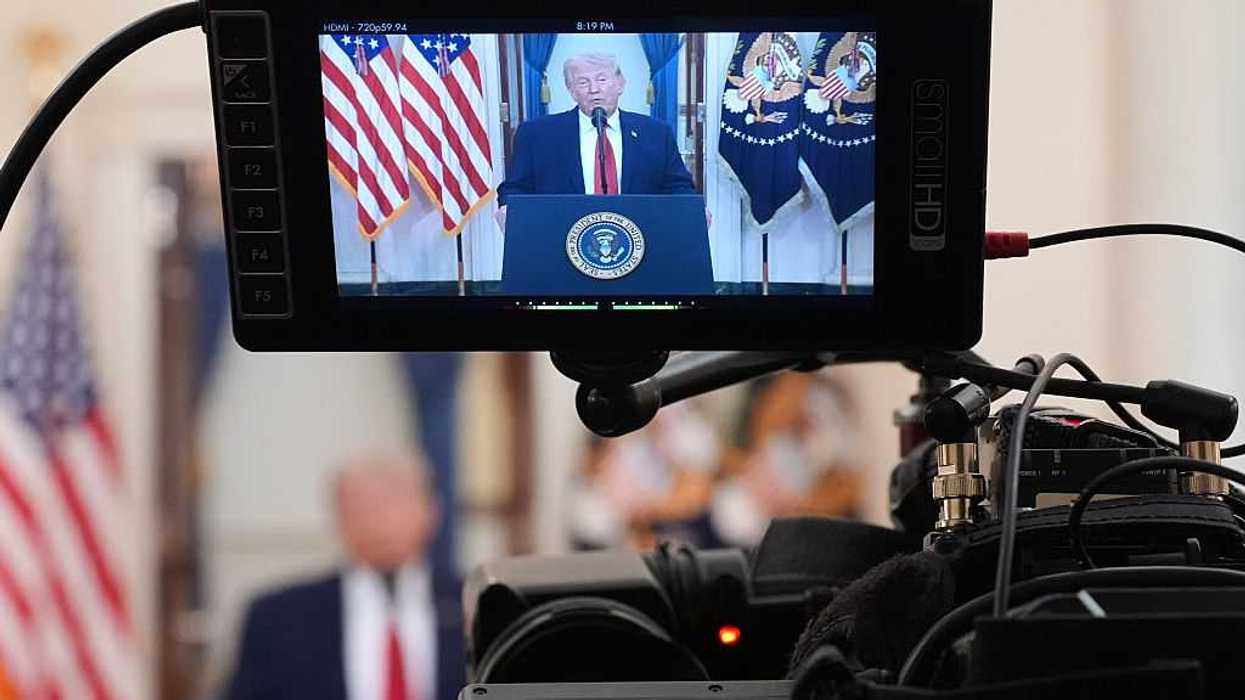 U.S. President Donald Trump is shown on television monitor.