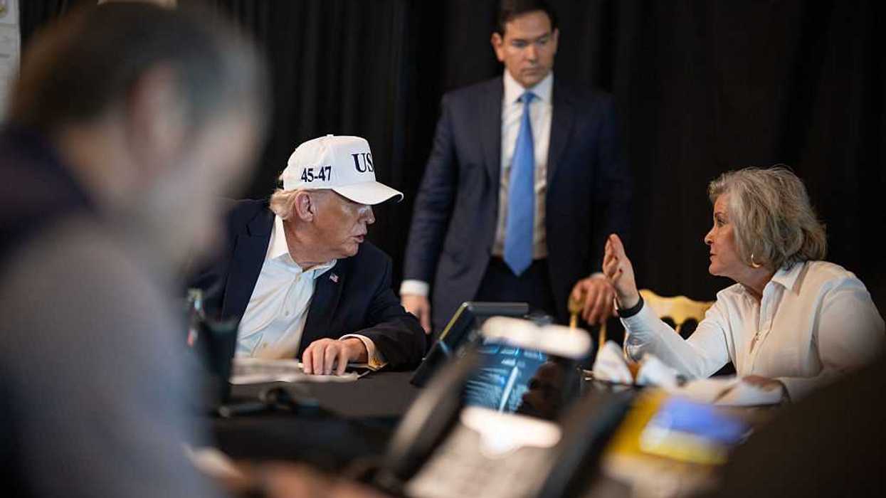 U.S. President Donald Trump (L) speaks to White House Chief of Staff Susie Wile.