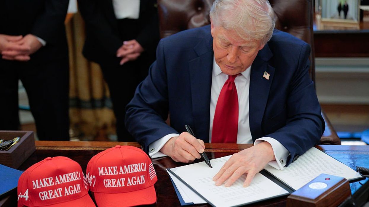 U.S. President Donald Trump signs an executive order in the Oval Office at the White House on April 23, 2025 in Washington, DC.