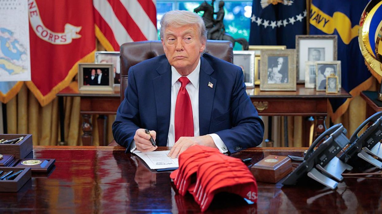 U.S. President Donald Trump signs executive orders in the Oval Office at the White House on April 23, 2025 in Washington, DC.
