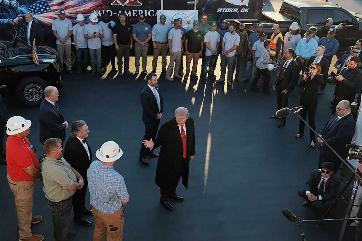 U.S. President Donald Trump speaks to a crowd and cameras outside.