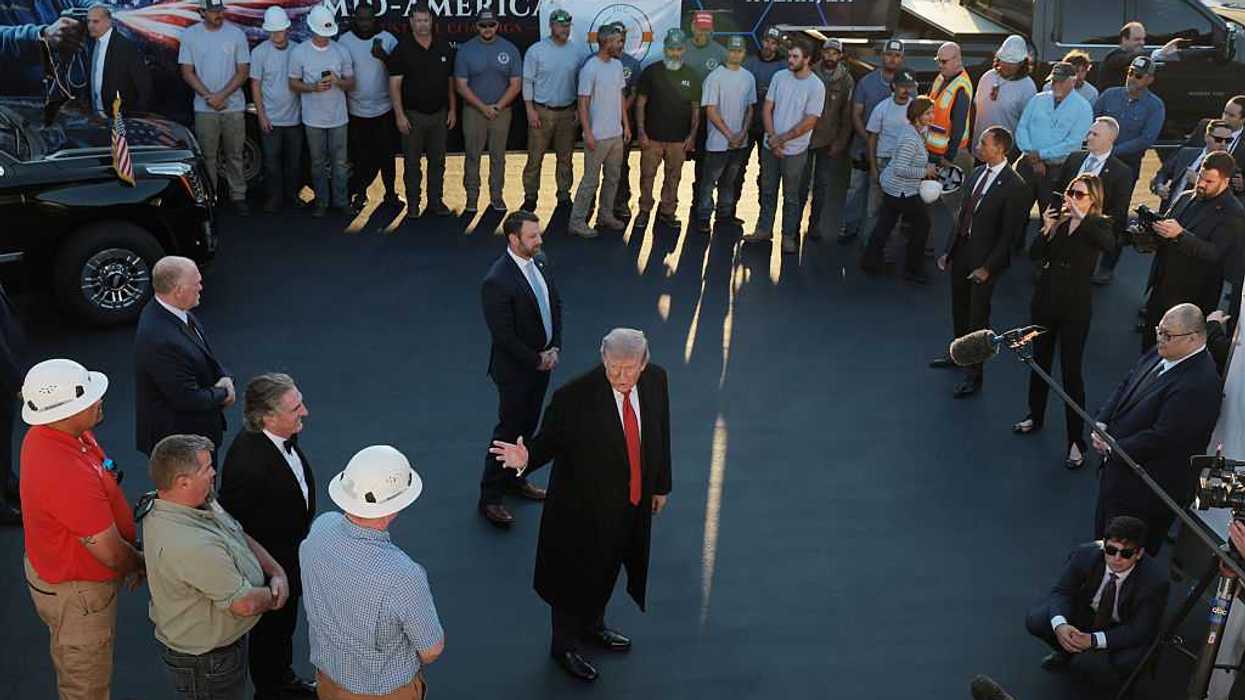 U.S. President Donald Trump speaks to a crowd and cameras outside.