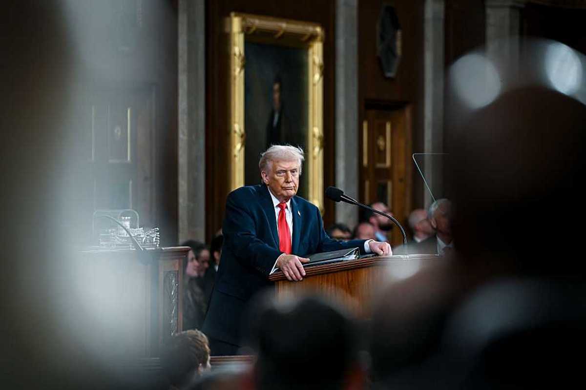 U.S. President Donald Trump standing at a podium.