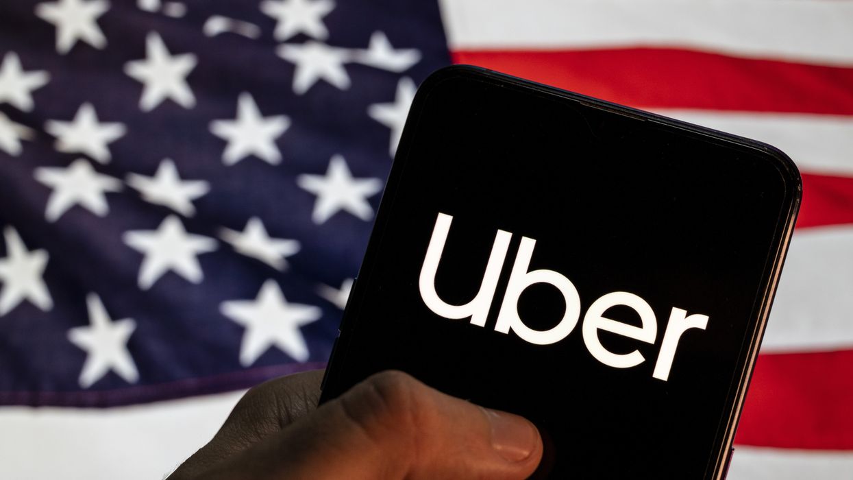 Uber logo in front of an American flag