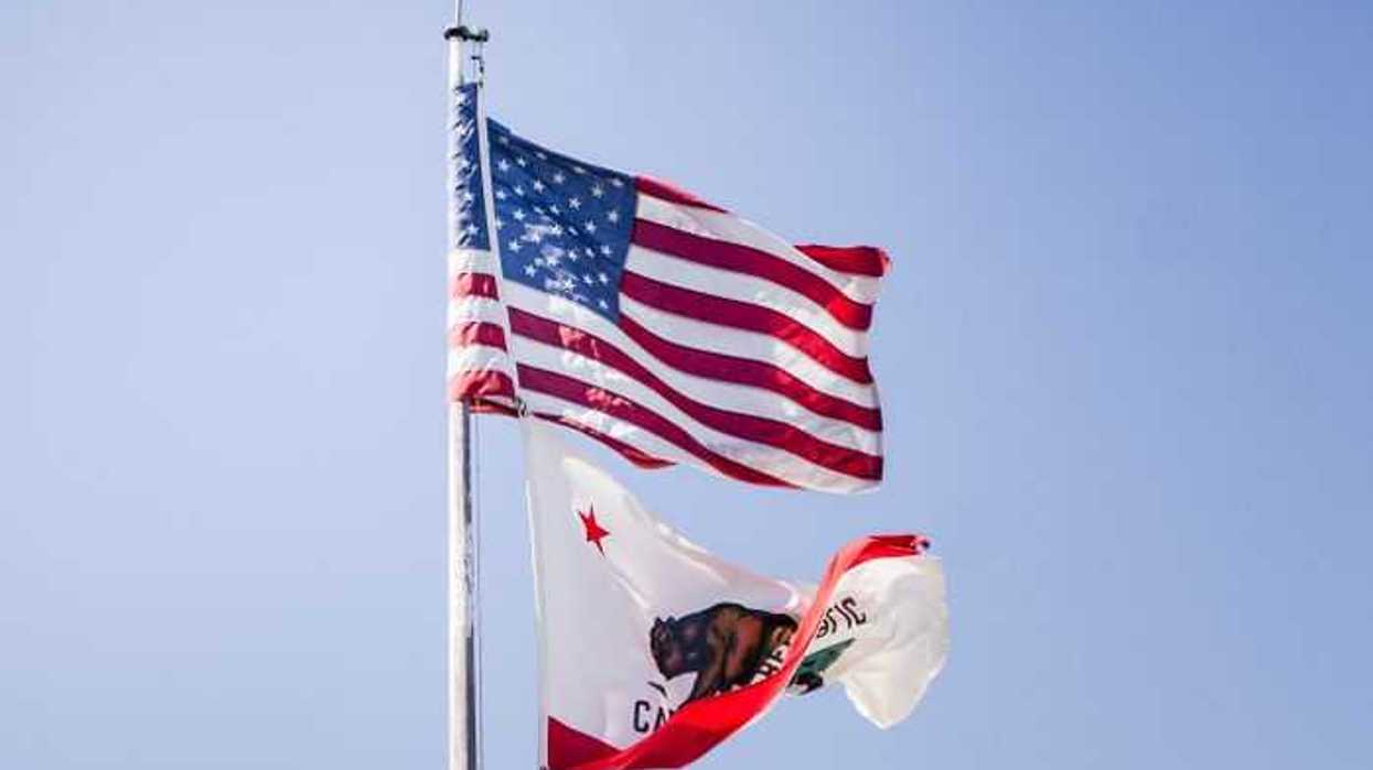 US and California flags waving on a poll