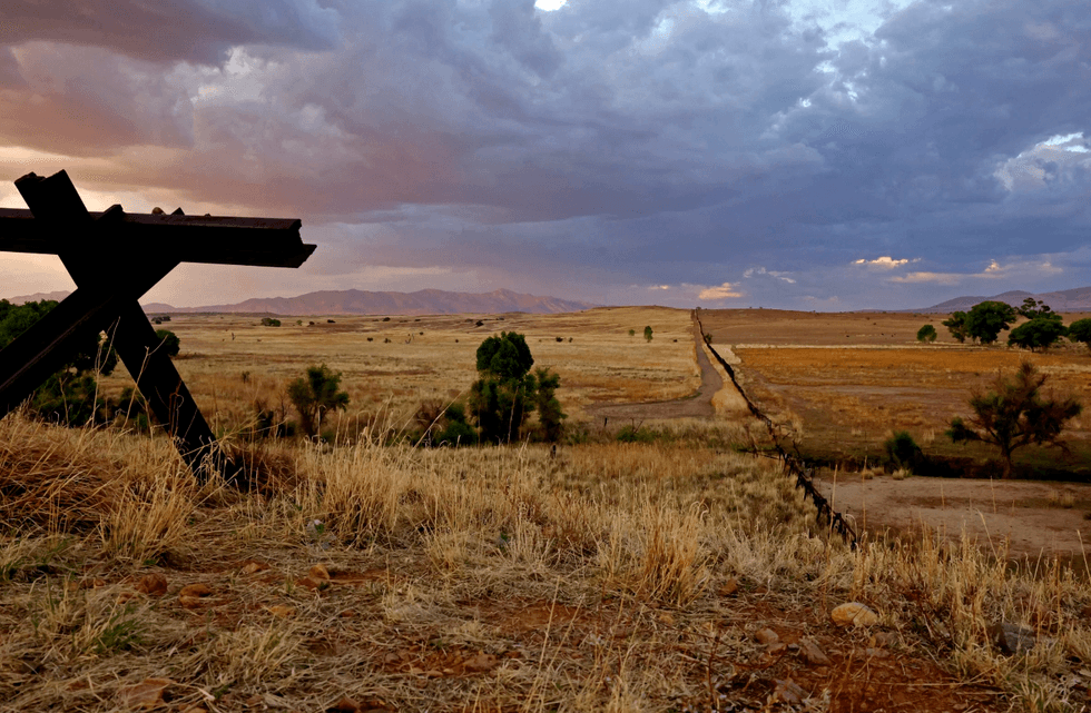 Vehicle barriers mark the border between the United States and Mexico in the San Rafael Valley