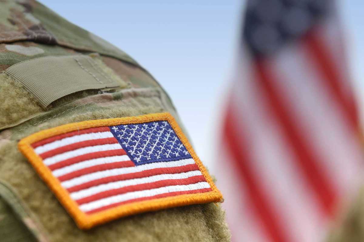 Veterans Day. US soldiers. US army. USA patch flag on the US military uniform and USA flag.