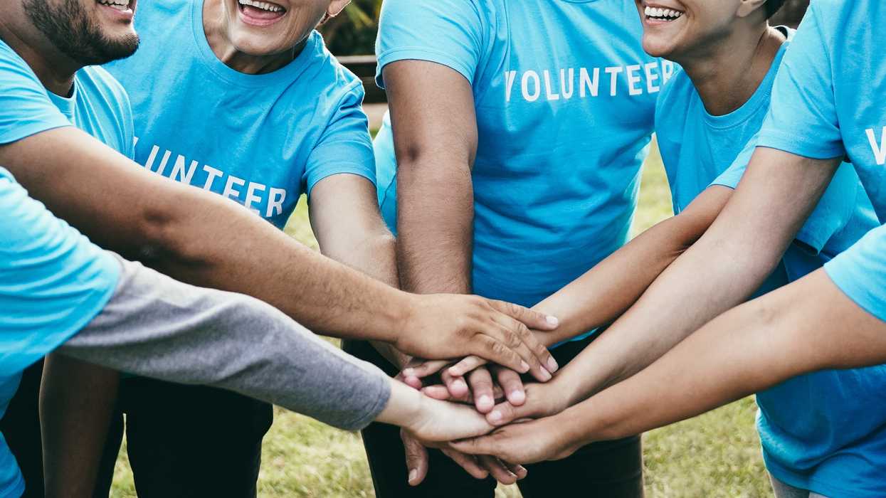 Volunteers putting their hands in