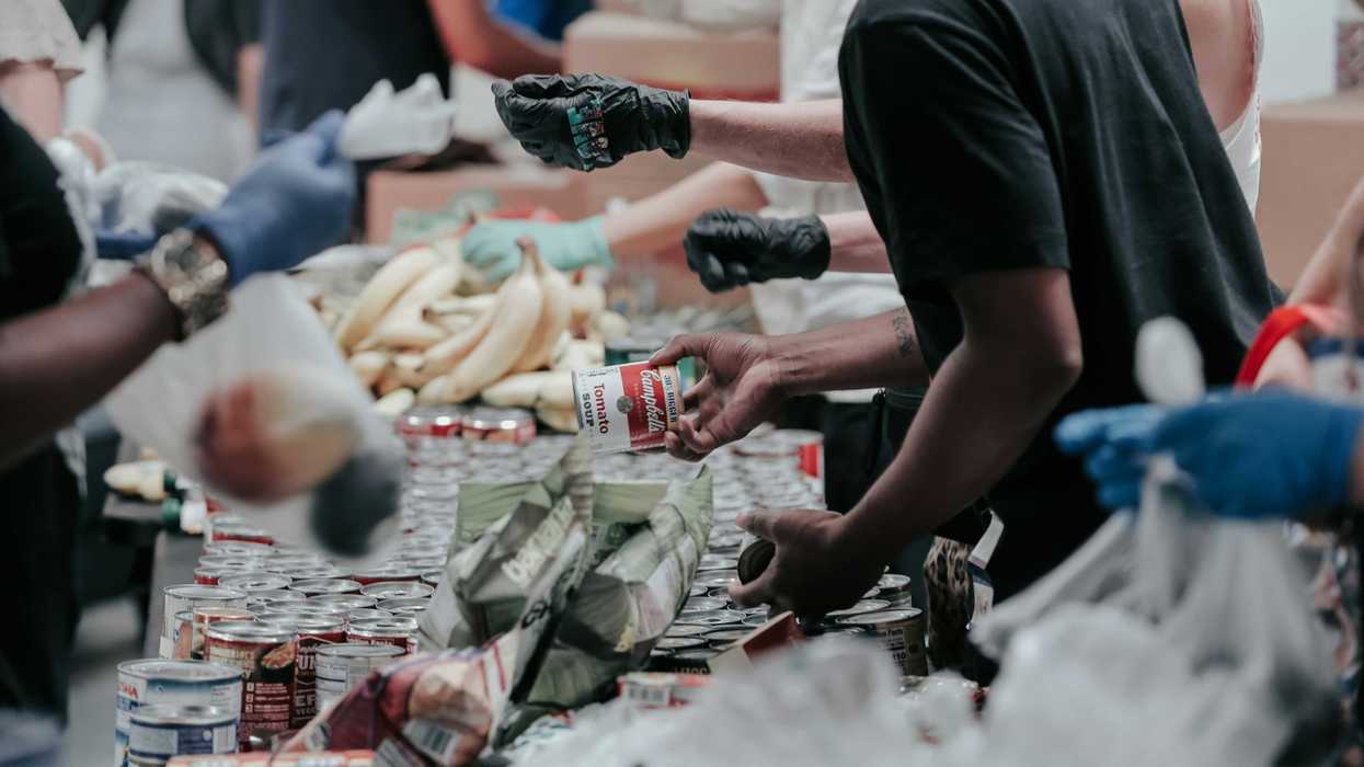 volunteers sort through canned food donations
