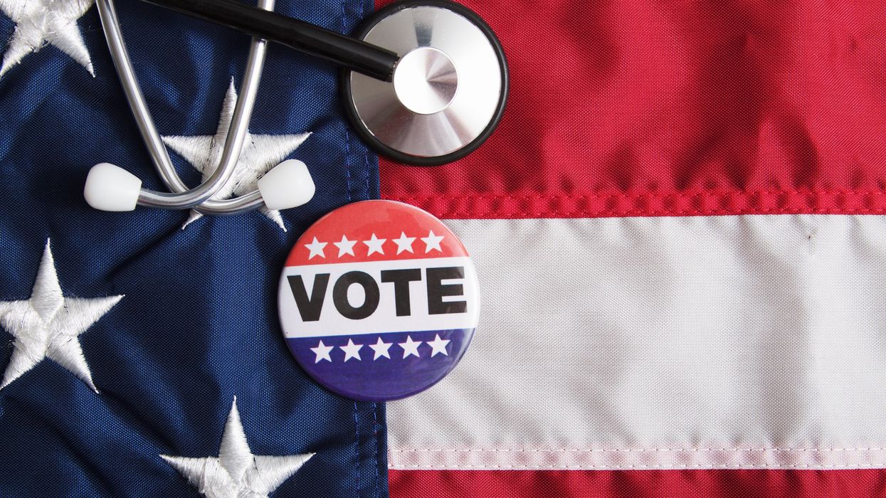 "Vote" pin and medical equipment on top of an American flag