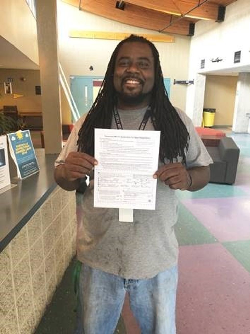 Voter shows off his application to restore voting rights