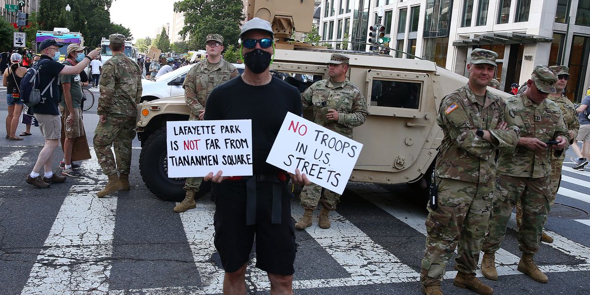 Washington, DC, protestors in front of National Guard troops