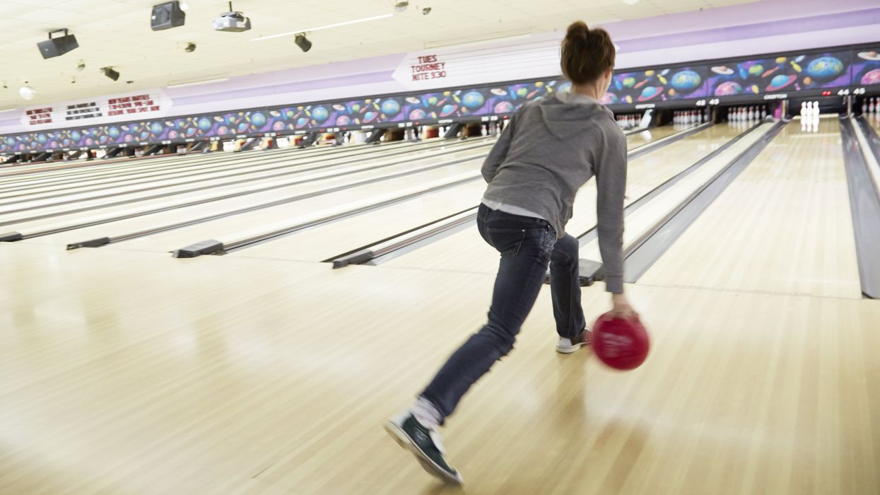 Woman bowling by herself