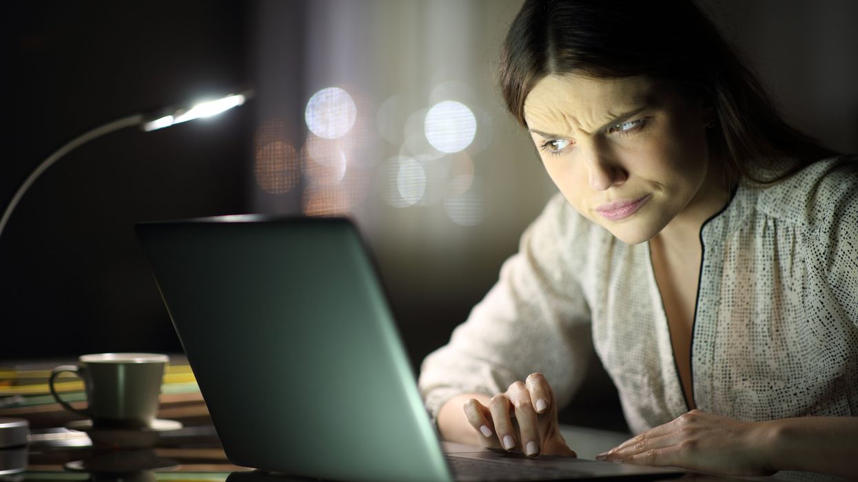 Woman cynically looking at her computer