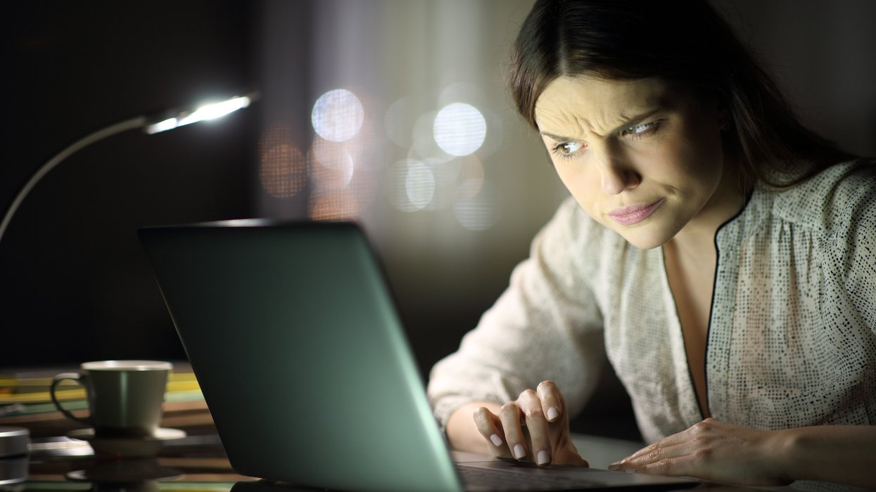 Woman cynically looking at her computer