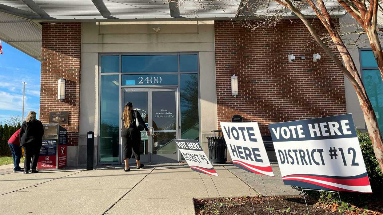 woman enters a building to vote