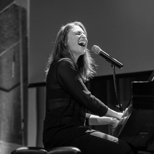 Woman playing the piano and singing