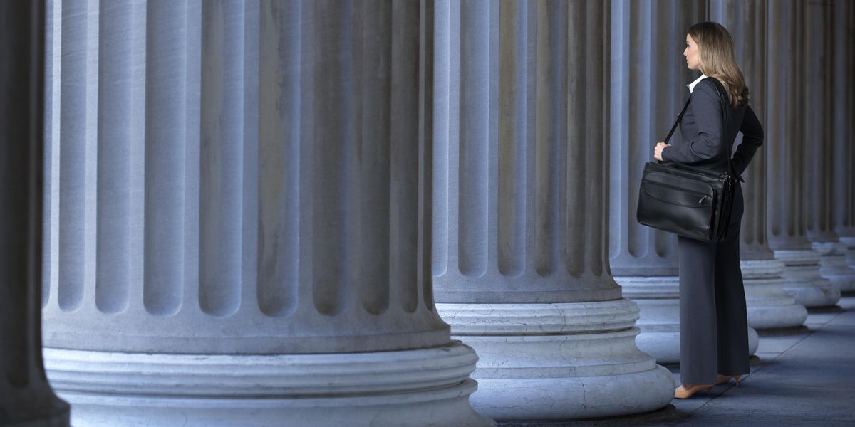 Woman standing alone near columns