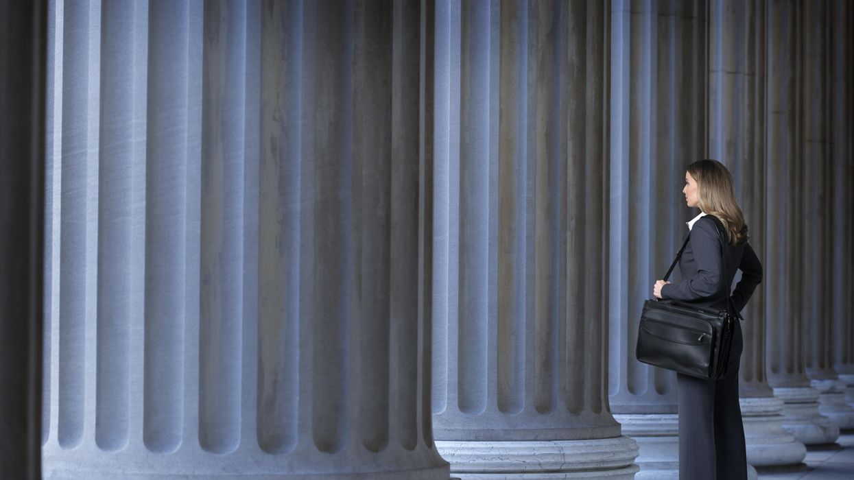 Woman standing alone near columns