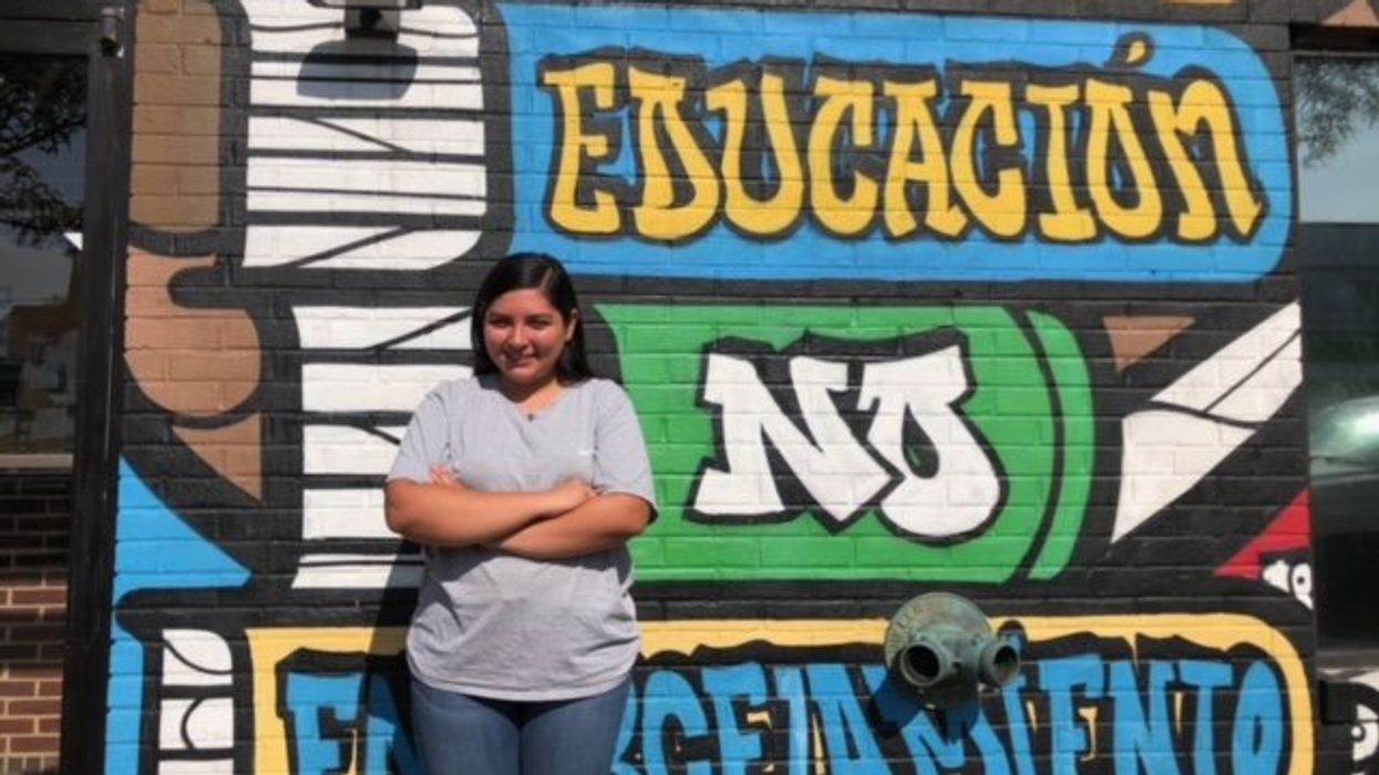 Woman standing in front of a mural