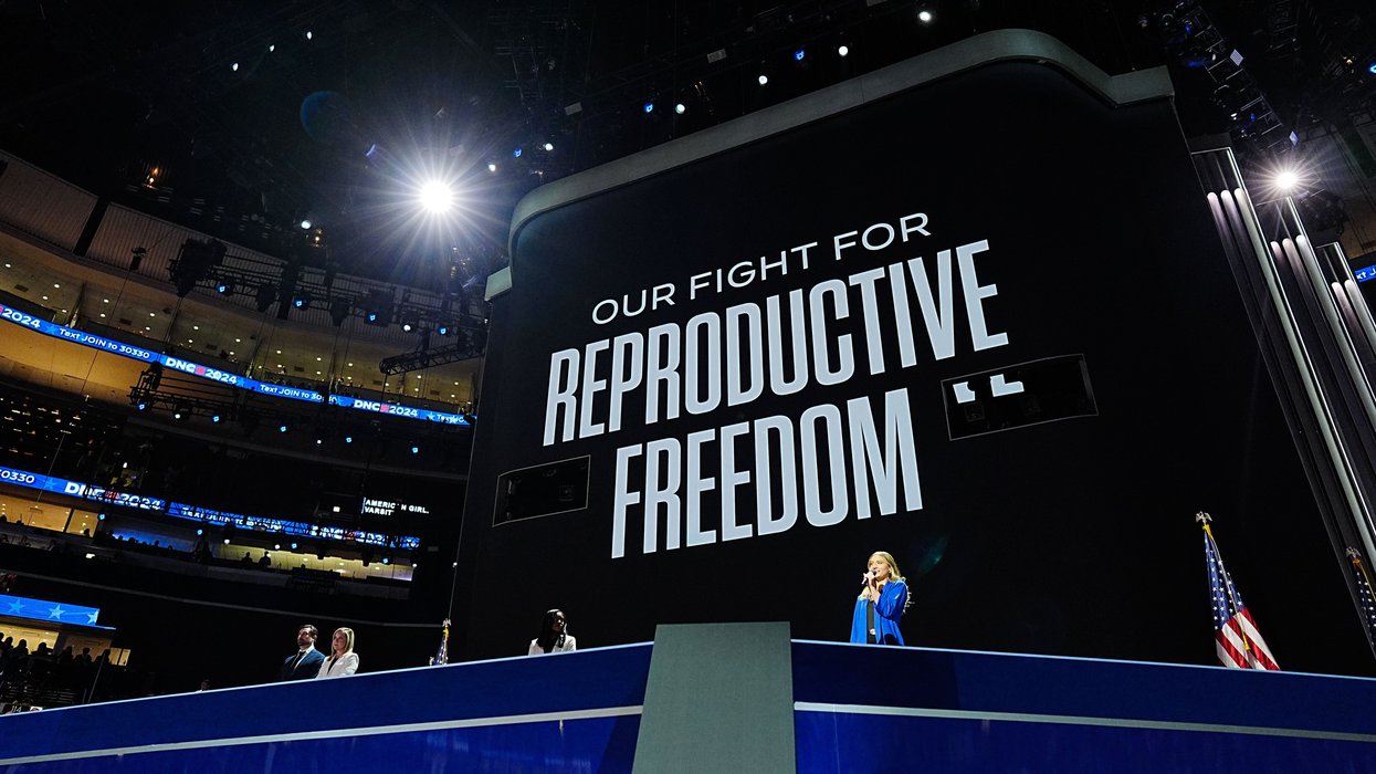 Women on state in front of a screen that reads "Our firght for reproductive freedom"