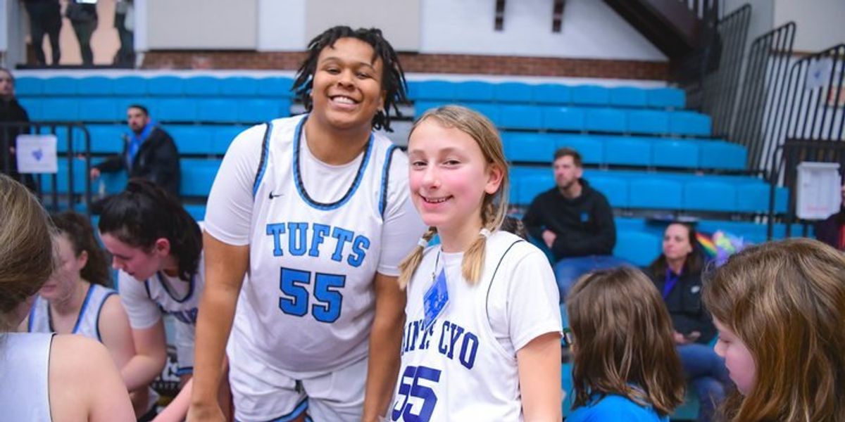 Women's college basketball player and young girl