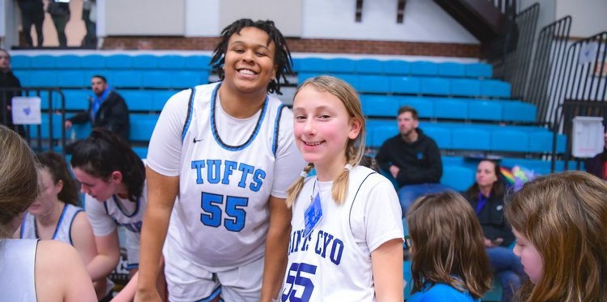 Women's college basketball player and young girl