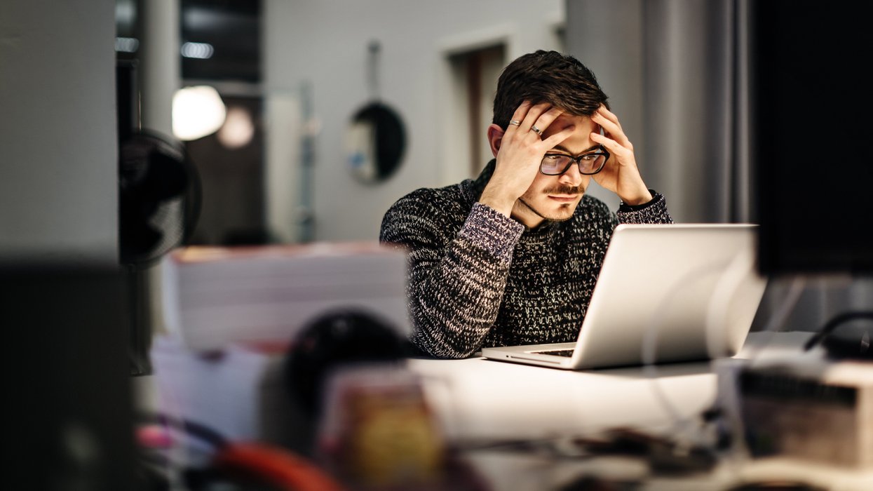 Young businessman holding his head and pondering