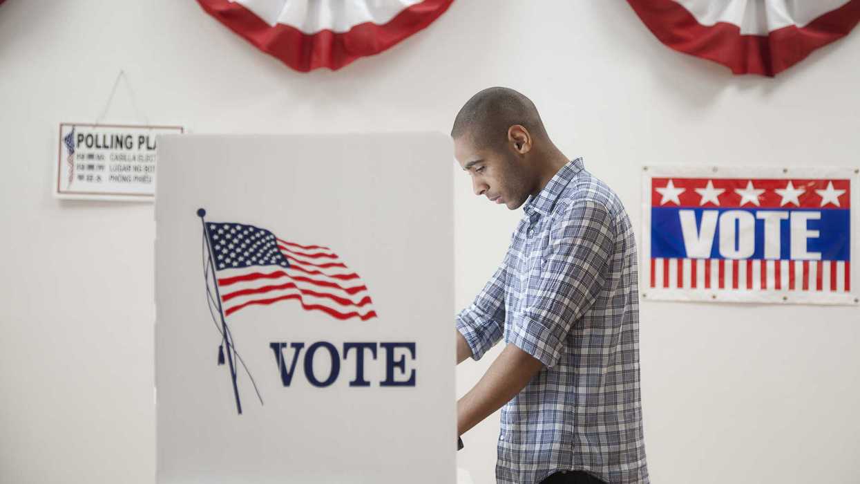 Young man voting in polling place