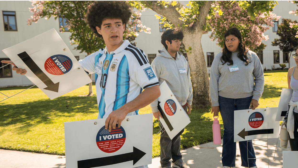 Young people holding "I Voted" signs