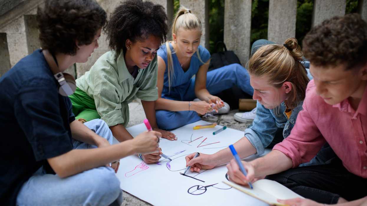 young people write on poster board for civic engagement