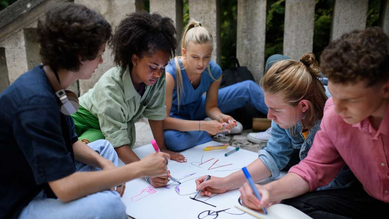 young people write on poster board for civic engagement