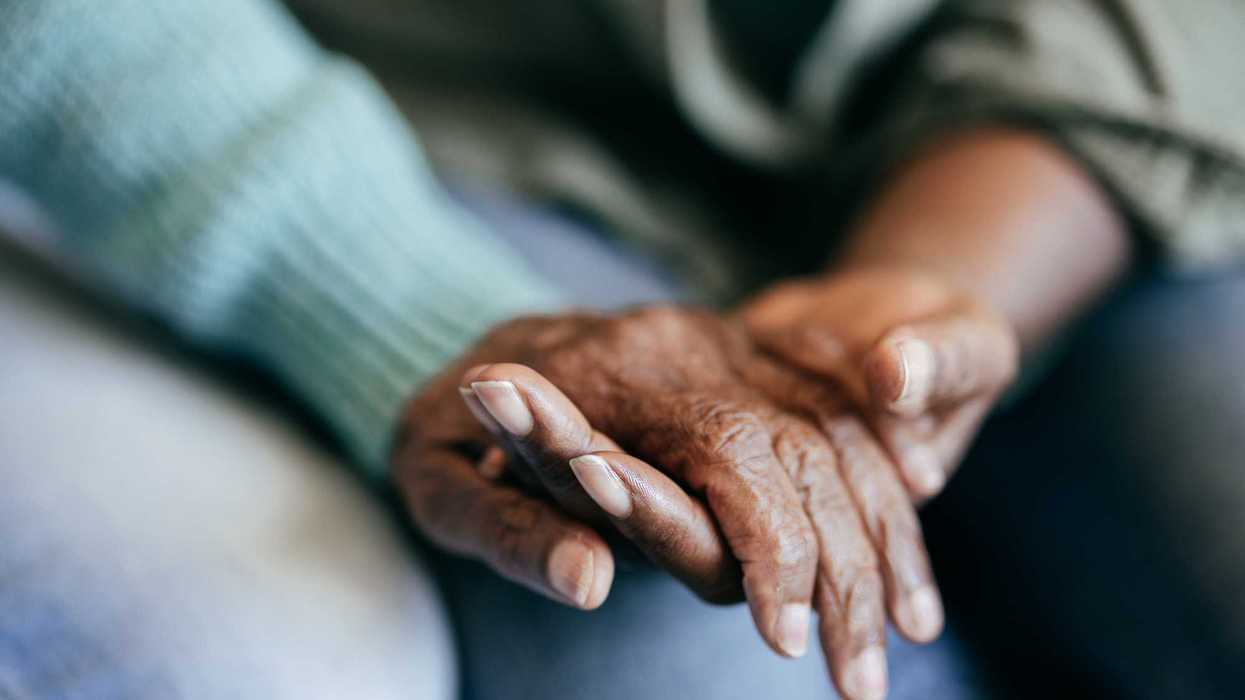 Young woman holding elderly hands